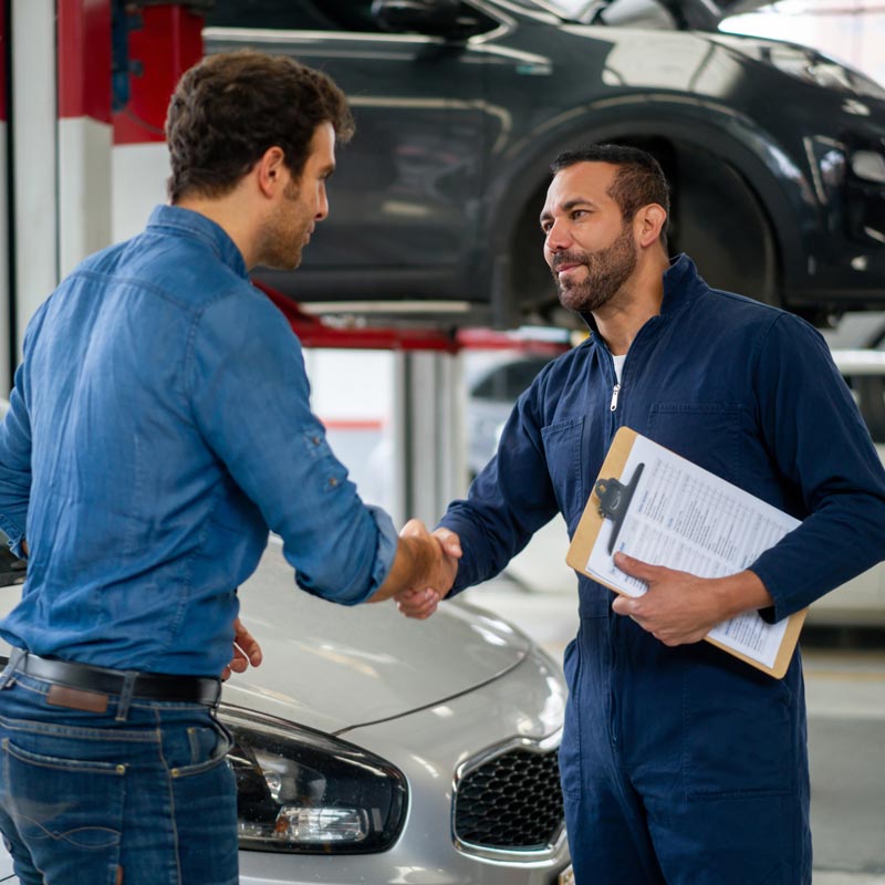 mechanic shaking hands with customer