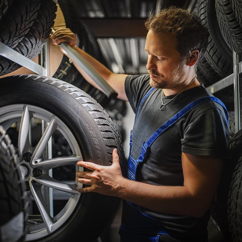 mechanic selecting tire
